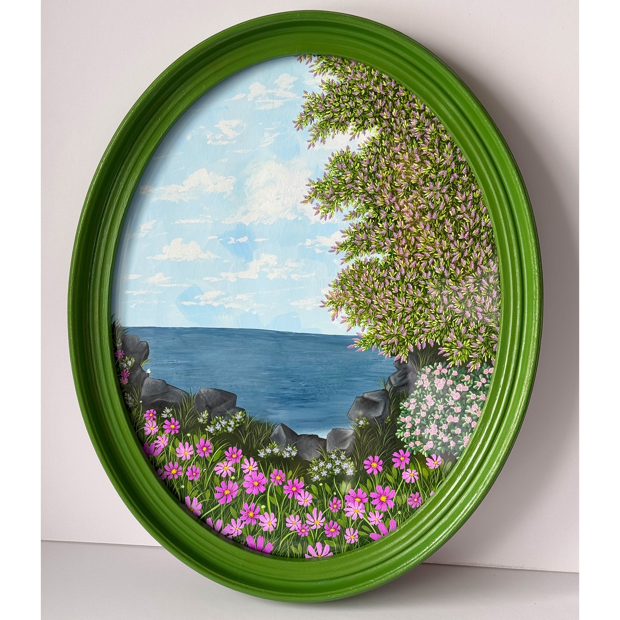A view of a calm ocean surrounded by cosmos flowers and lilacs. A peaceful setting and reflections of a journey.