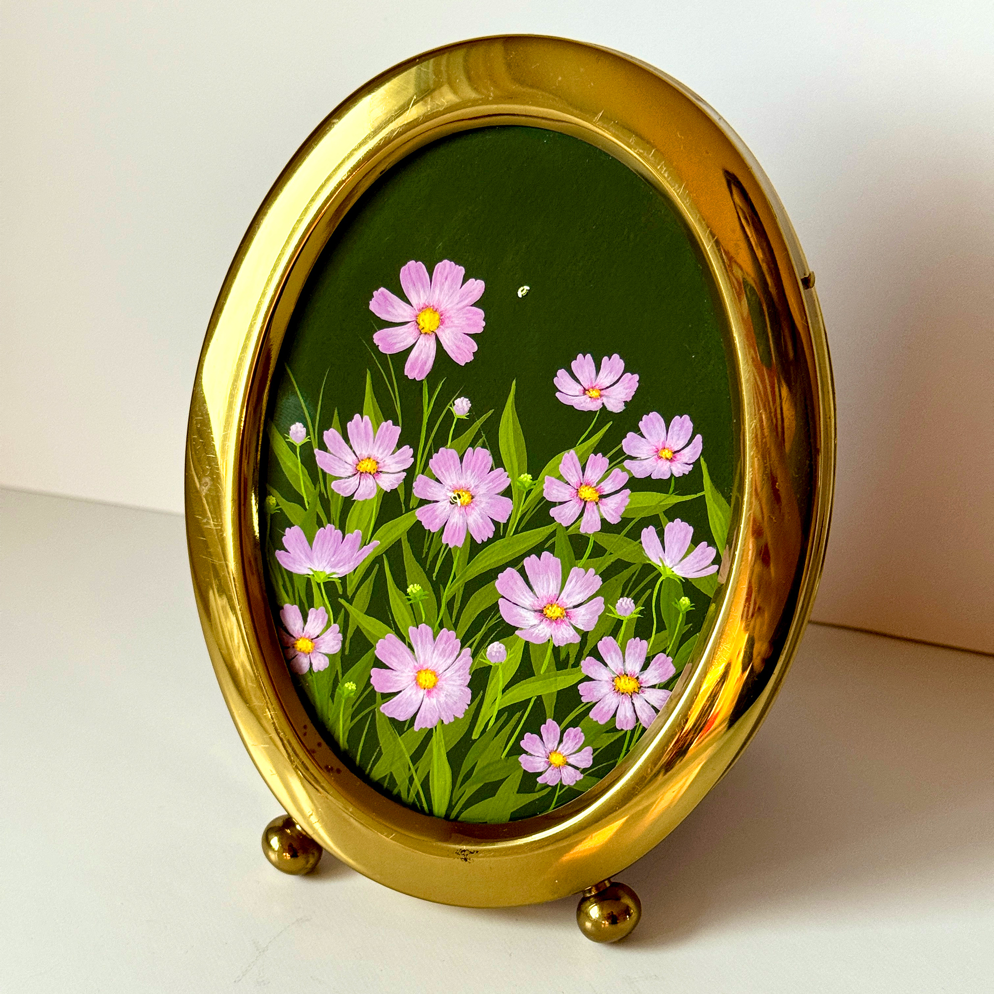 Pastel purple cosmos flowers magically flourish in a deep setting.