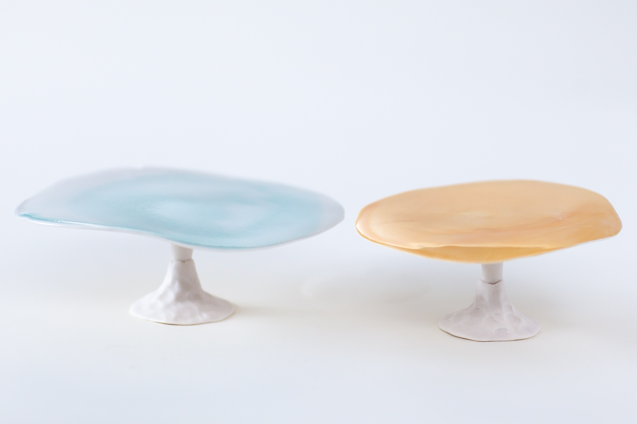 Footed porcelain plate for any bakery,  bonbons etc…that is reminiscent of lil pad or mushrooms handbuilt glazed on top under unglazed polished porcelain