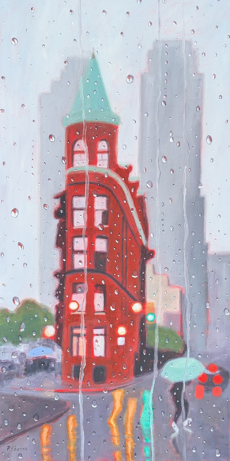 A pedestrian heads across the street in Toronto with the Flat Iron building behind her. 