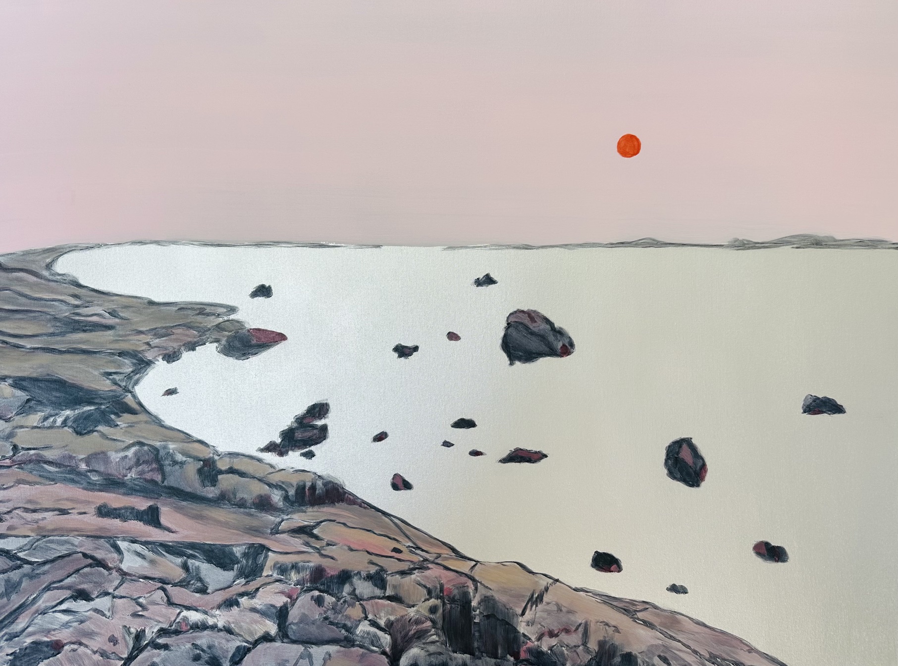 Orange sunset in a soft pink sky overlooking rocks and an ethereal silver metallic water