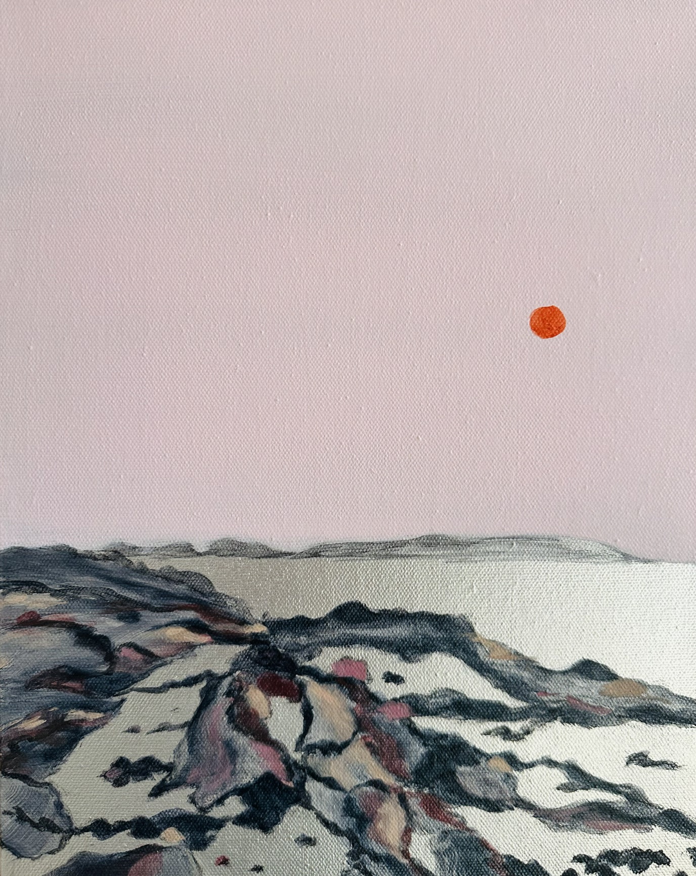 Orange sunset in a soft pink sky overlooking rocks and an ethereal silver metallic water