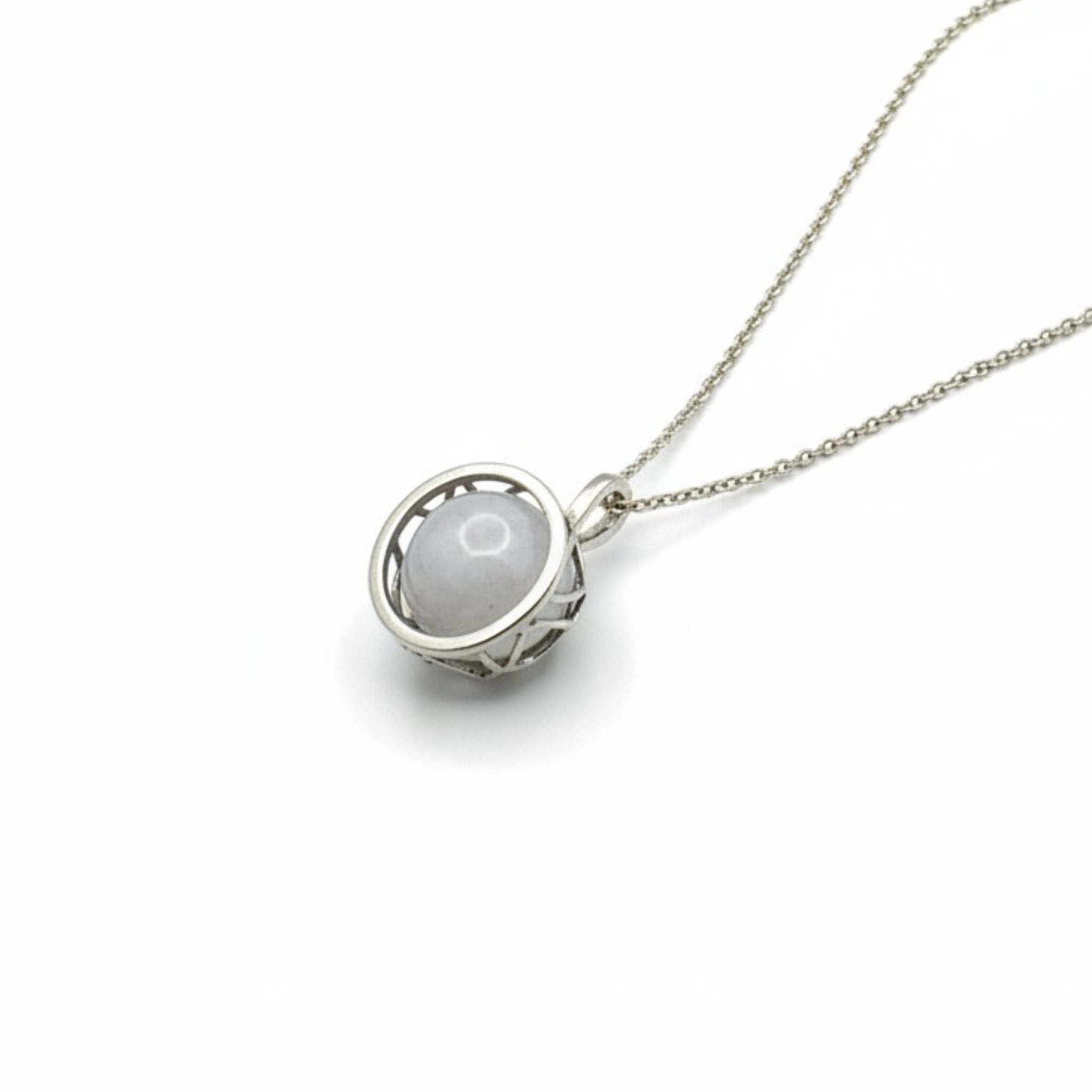 Recycled sterling silver pendant featuring a textured metal nest holding a smooth white quartz gemstone.
